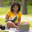 Student studying on the lawn