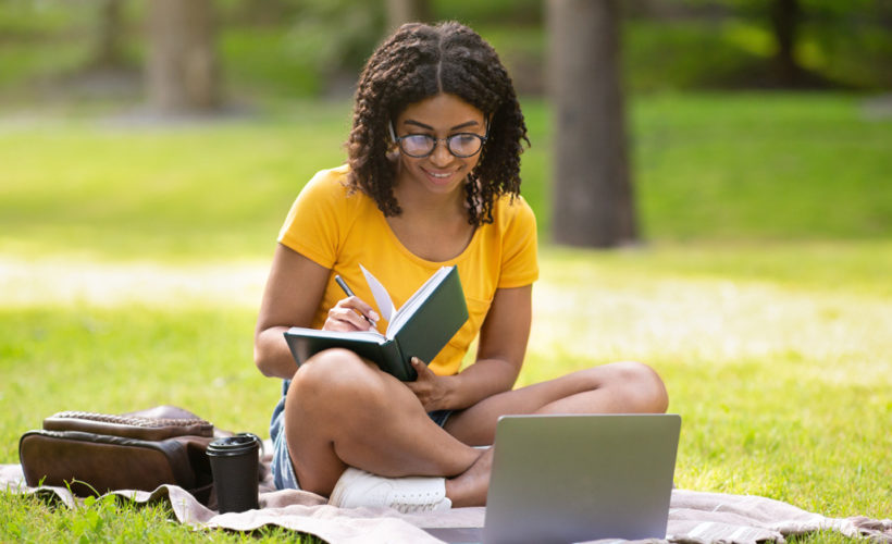 Student studying on the lawn